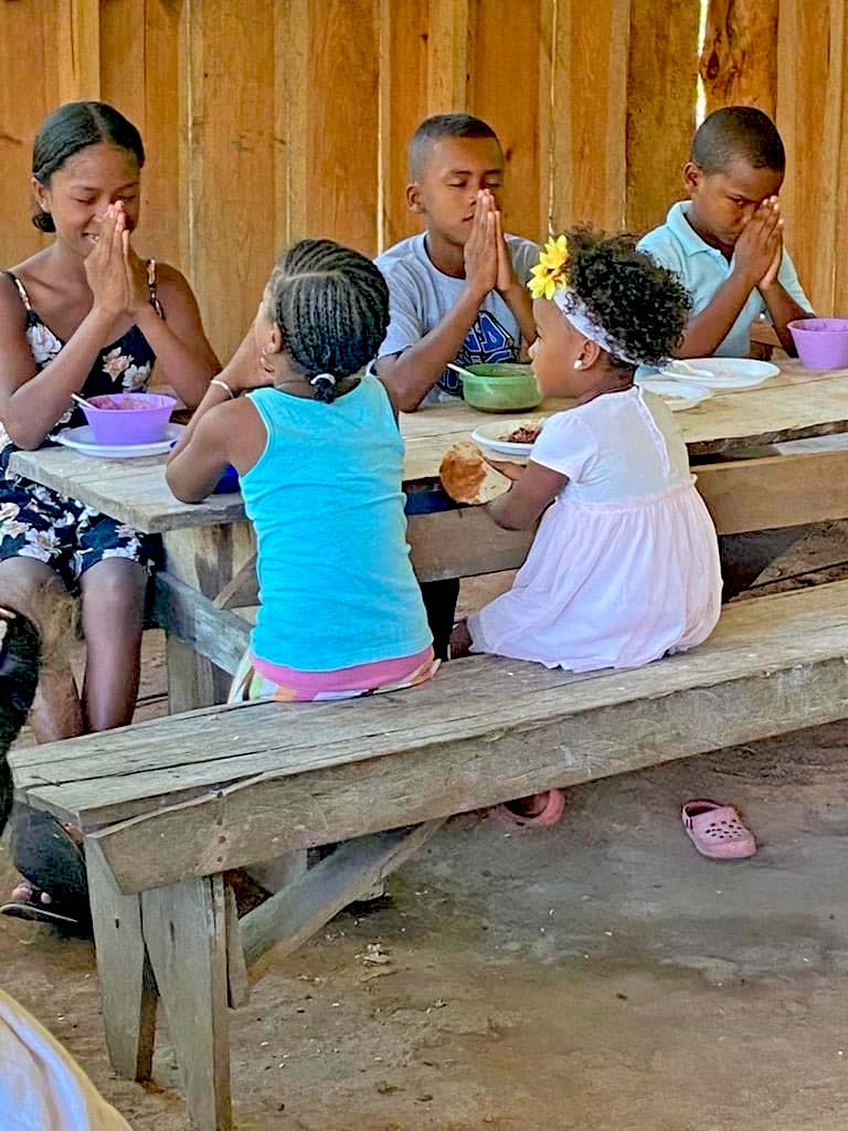 Moravian children in Honduras pray before eating the food your gifts provide.