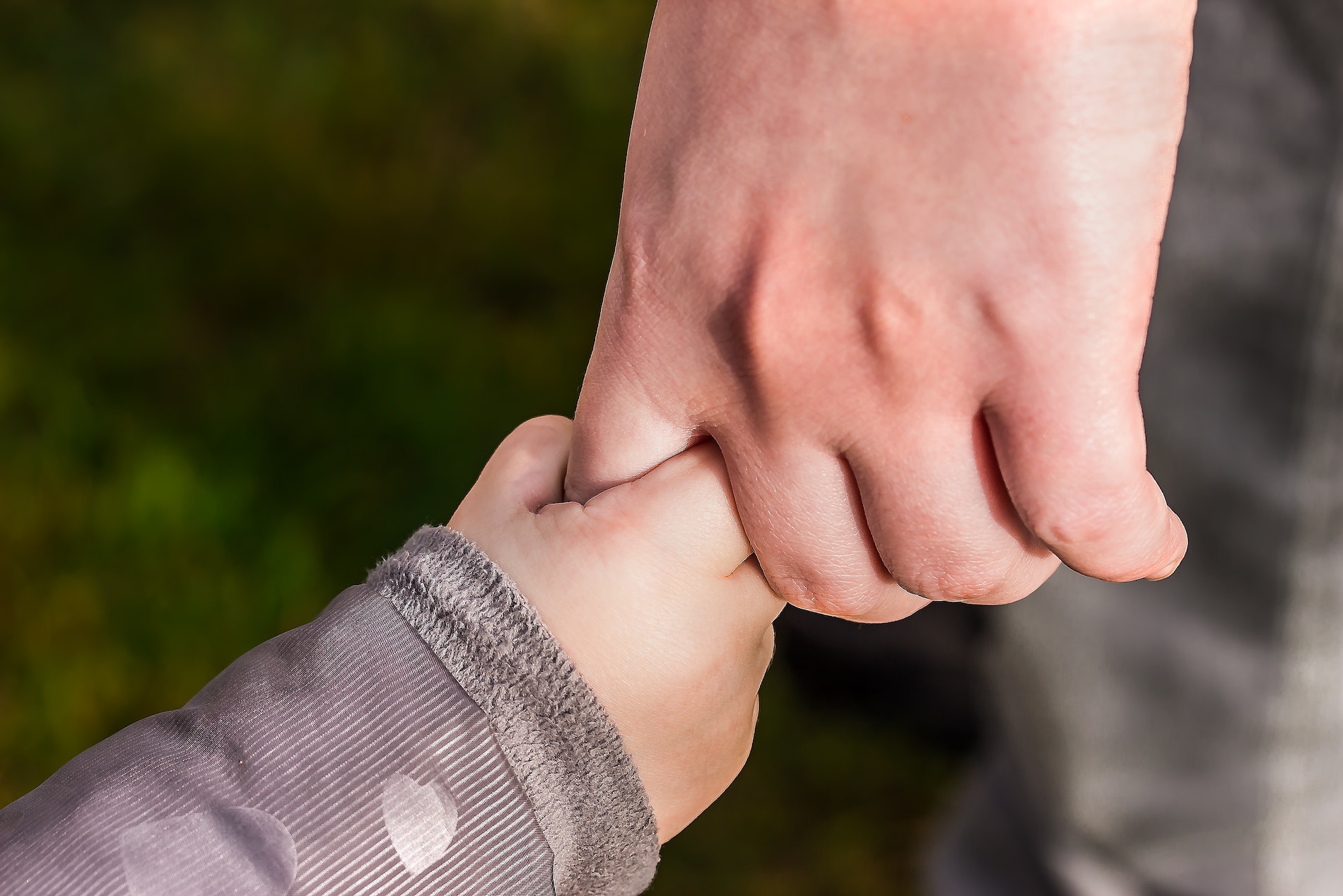 Adult holding child's hand. MMFA Will Estate Planning